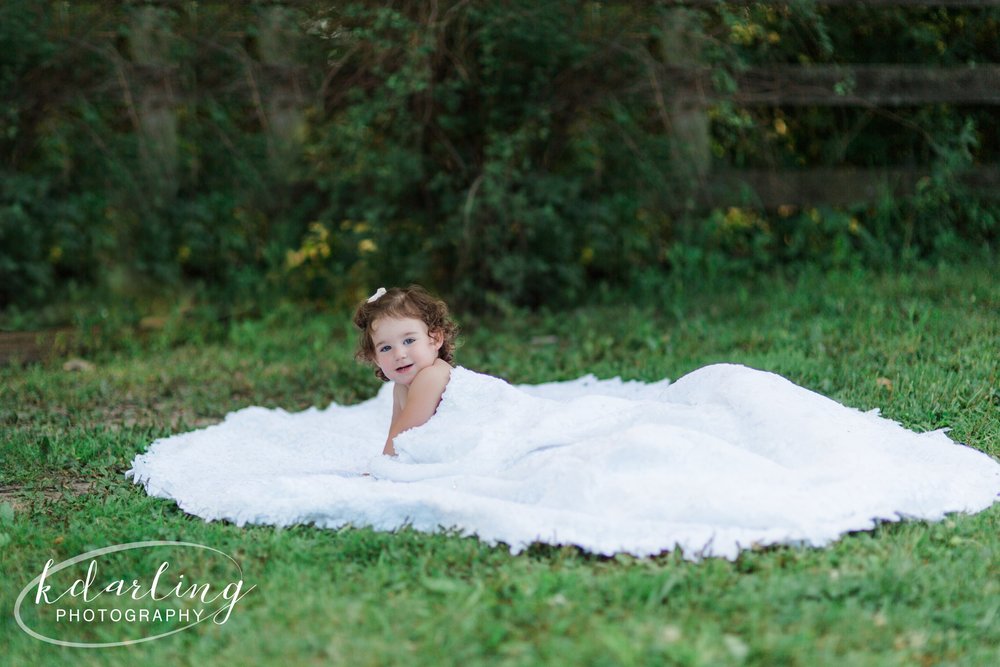 2 year old in mom's wedding dress