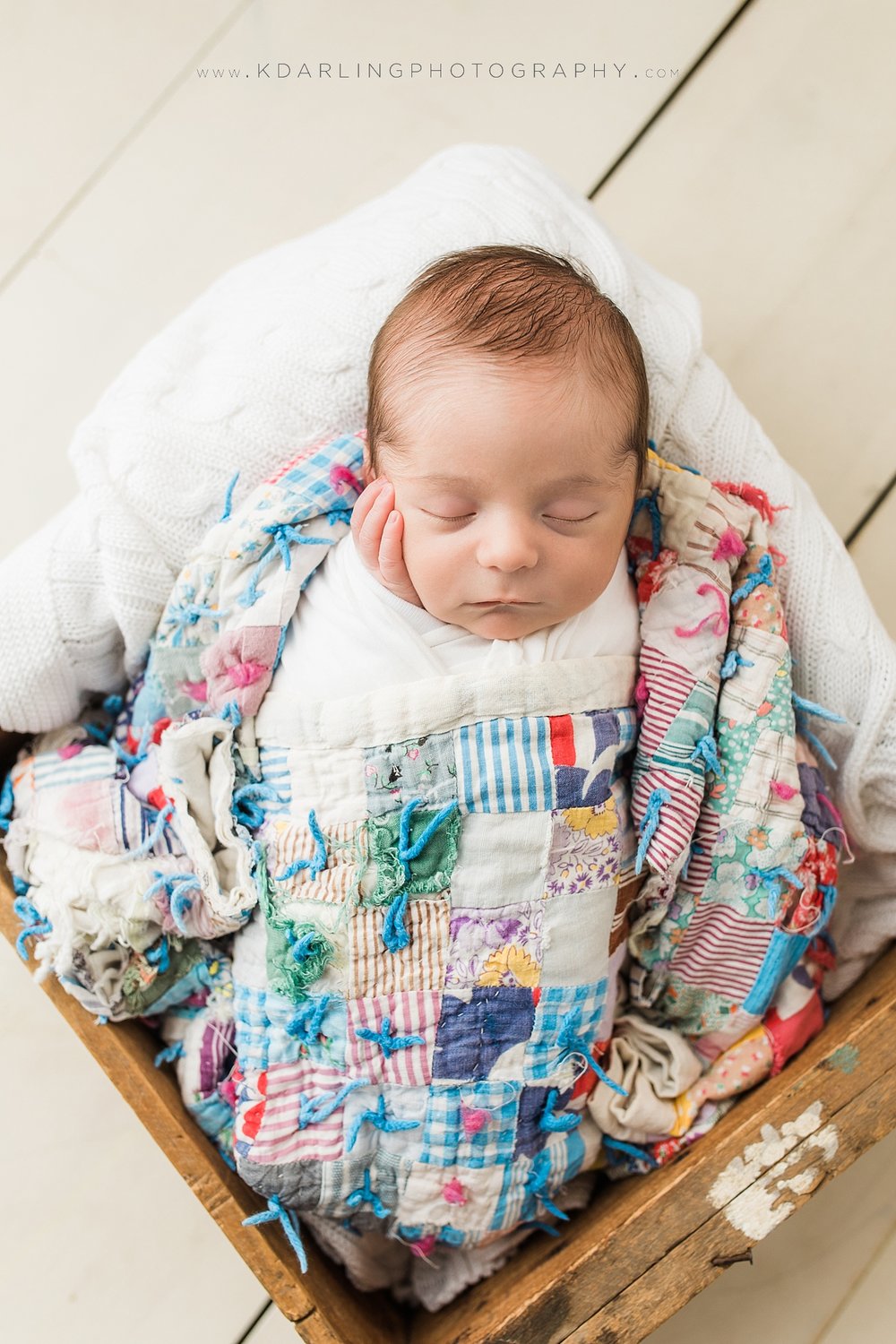 Newborn baby wrapped in a quilt