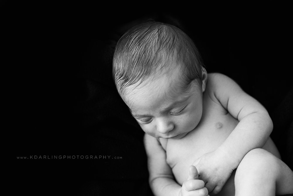 Simple black and white image of newborn boy