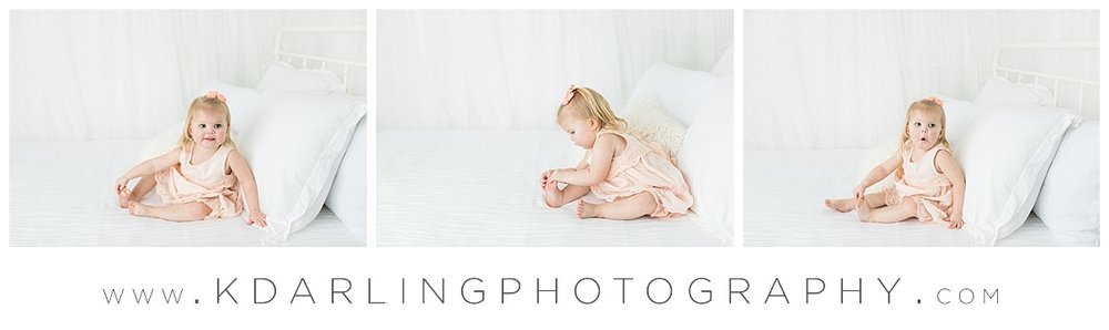 Studio photos on white bed in peach dress