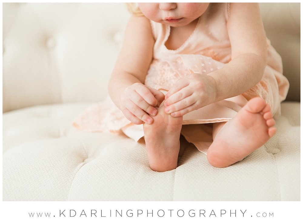 Little girl playing with her toes