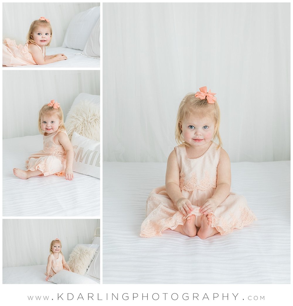 Studio session on white bed with two year old girl