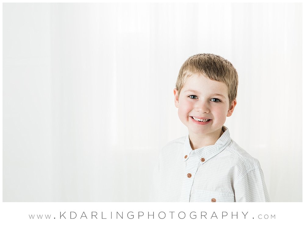 Six year old boy smiling in studio