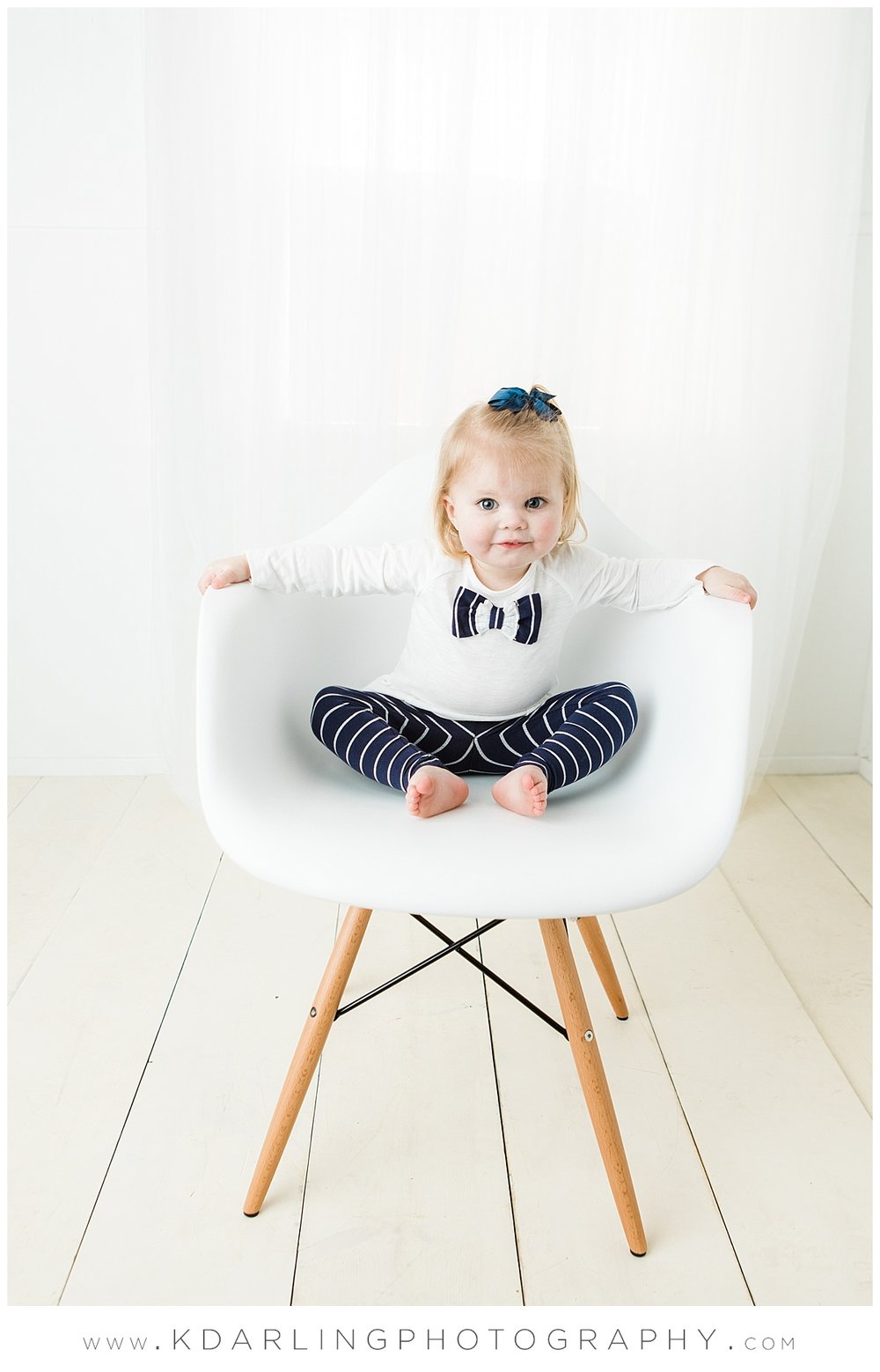 Two year old girl in white chair