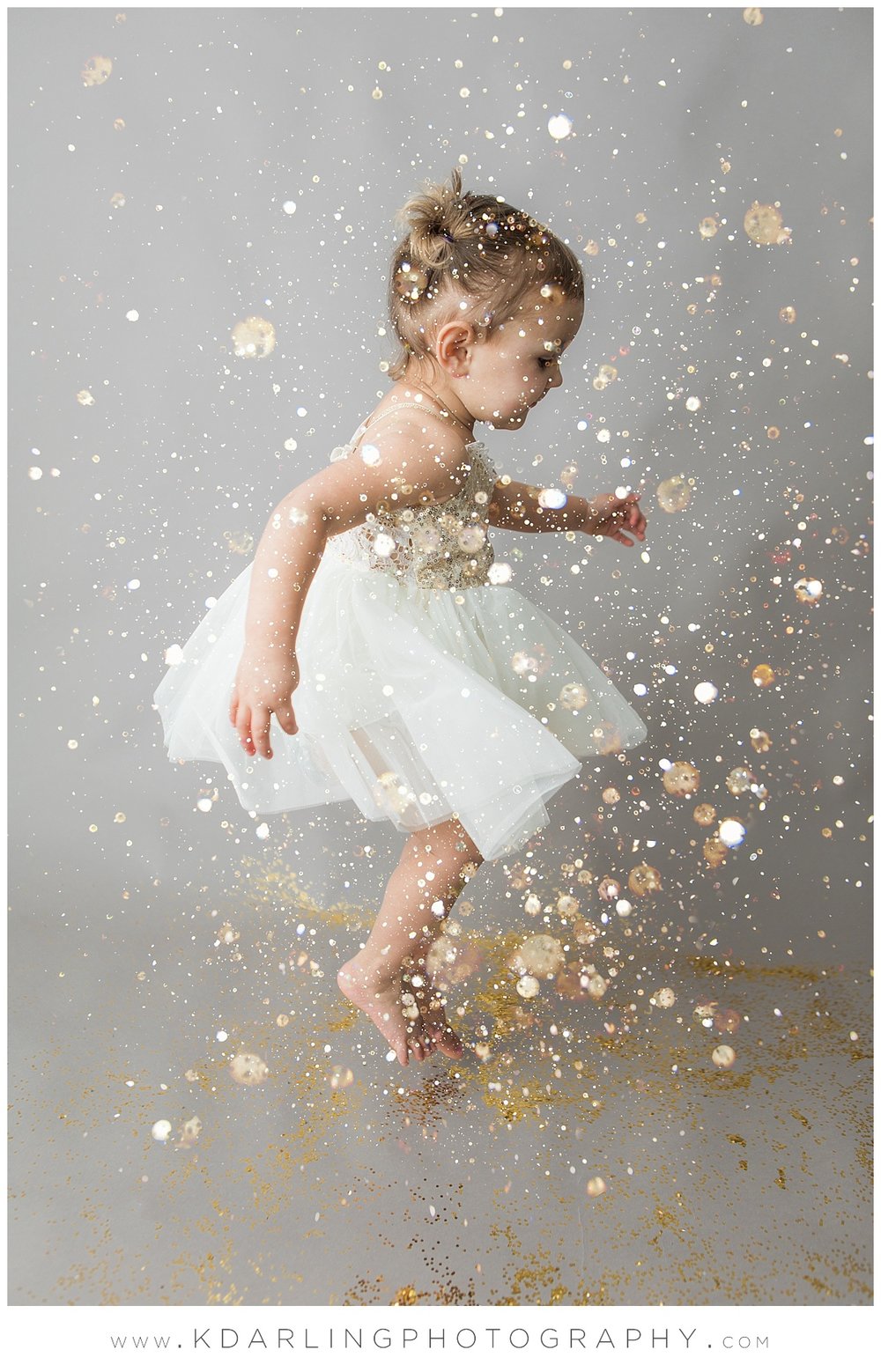 Two year old jumping in glitter