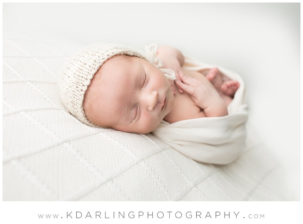 Newborn baby sleeping with hands on chest