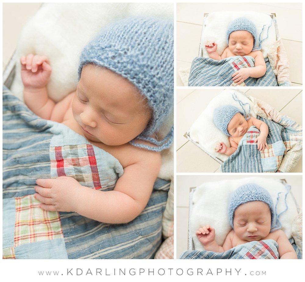 Newborn baby boy in blue bonnet with quilt
