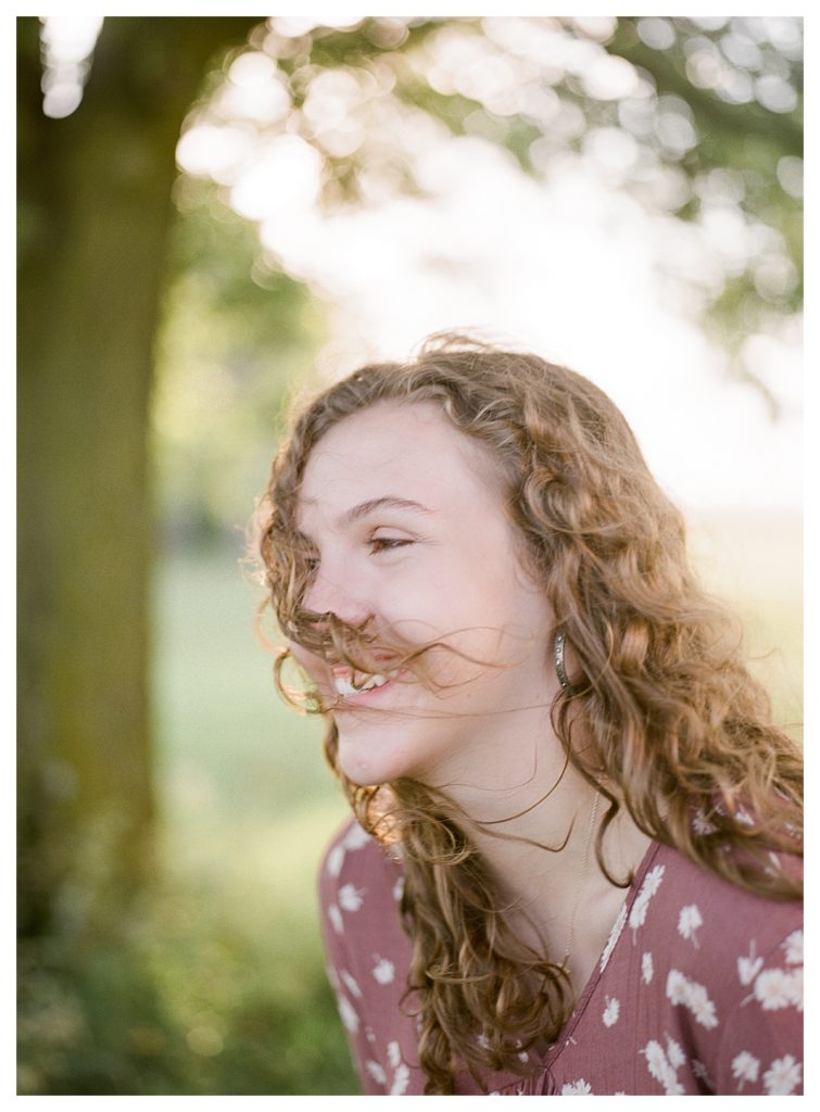Iroquois West High School senior girl with curly hair laughing