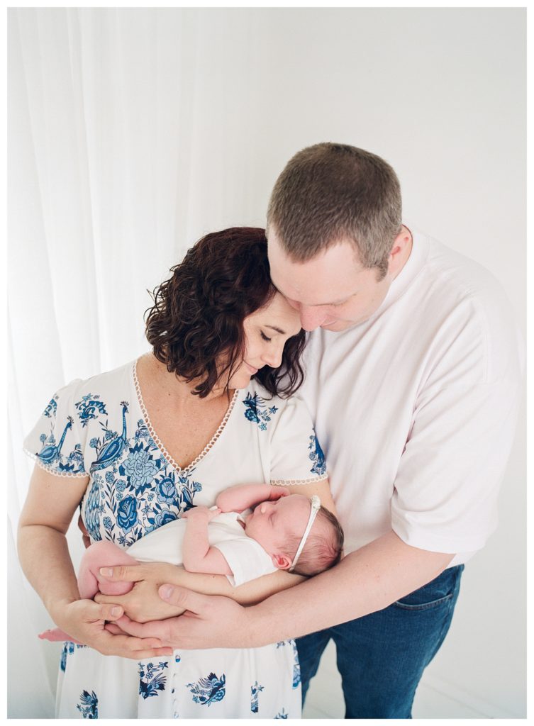 Newborn baby with parents mom in floral dress